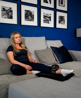 Women sat on mini mat with CELLER8 around ankle