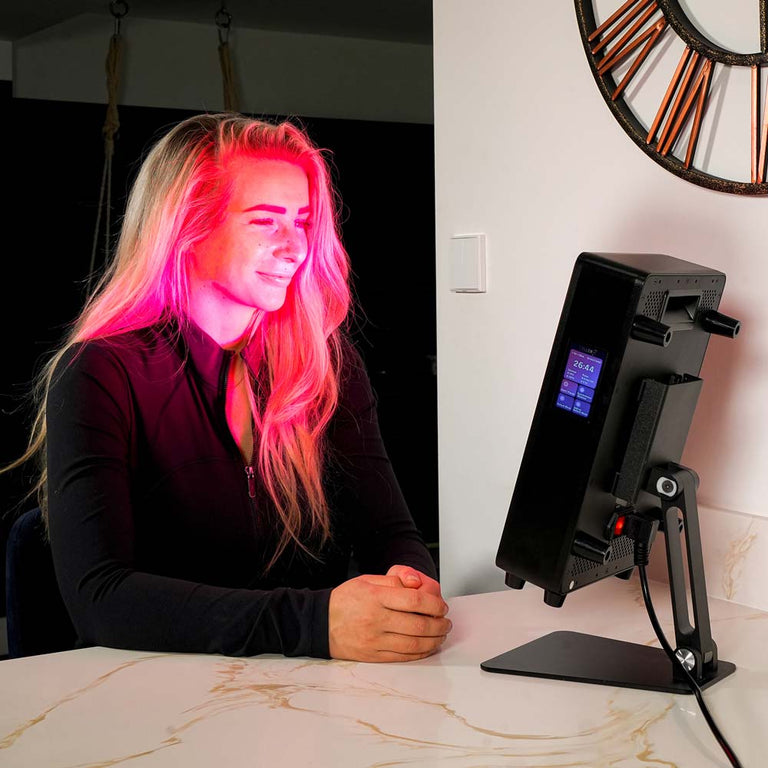 Lady sat using red light panel