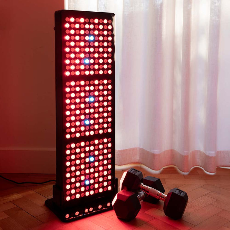 CELLER8 red light panel with weights stacked to the side