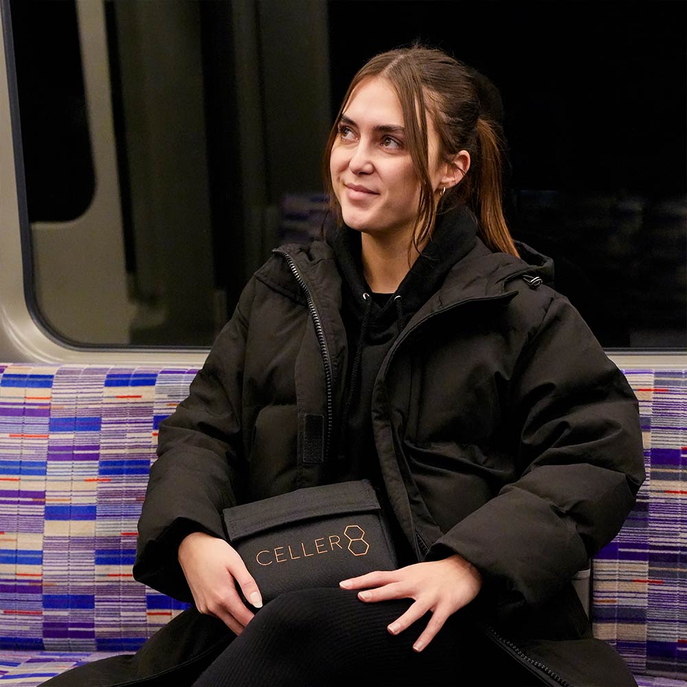 Holding CELLER8 carry bag on train