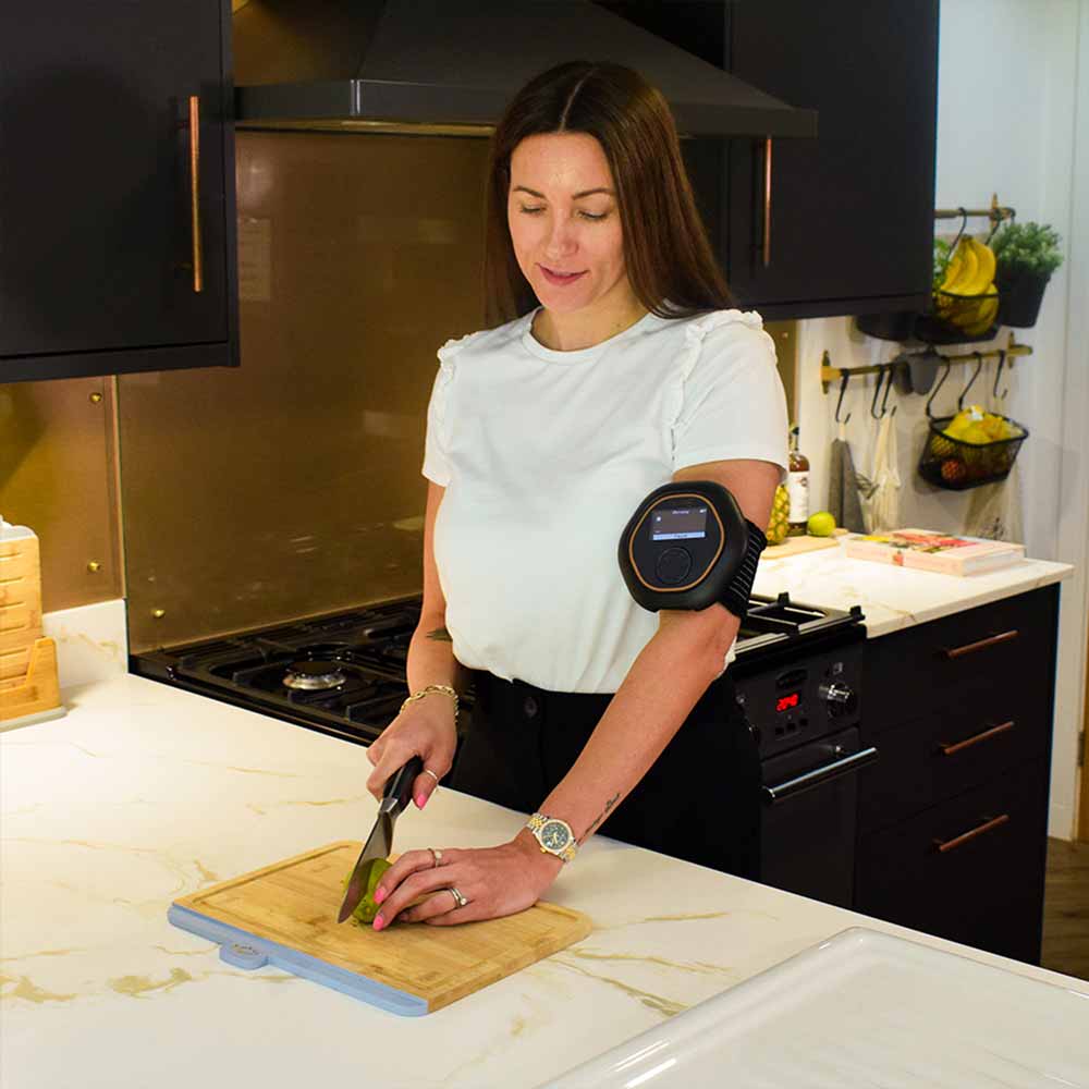 Women chopping fruit with CELLER8 on arm