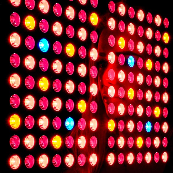 Women's reflection in full body red light panel 