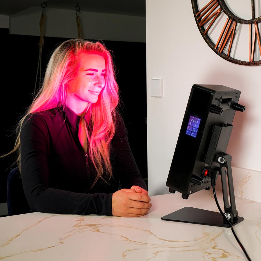 Women sat in front of desktop red light on kitchen counter 