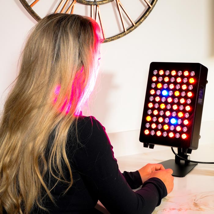 Women sat in front of desktop red light on kitchen counter 