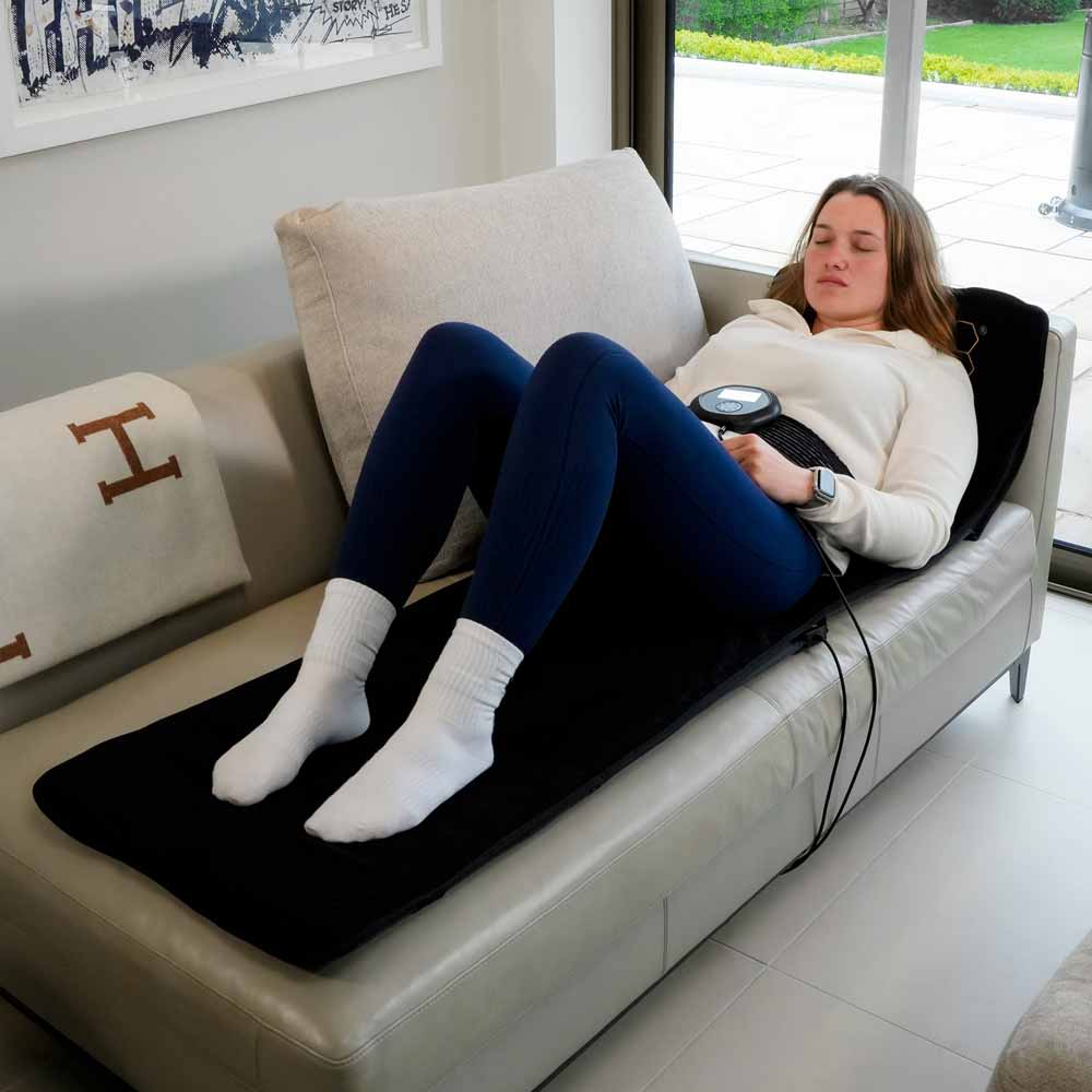 Women laying on CELLER8 full body mat with CELLER8 strapped to waist