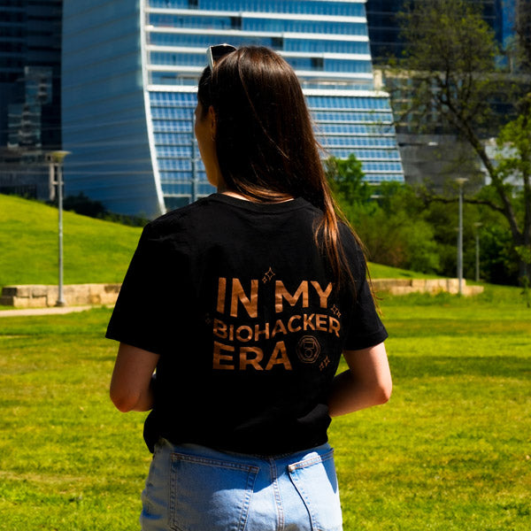 Women walking through park wearing biohacker era t-shirt