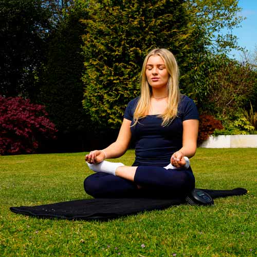 Women outside on grass doing mediation on CELLER8 full body mat