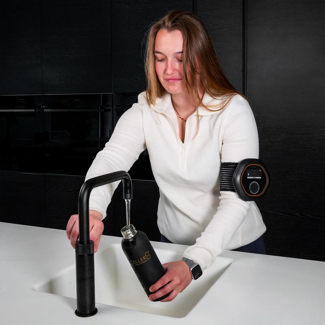 Women wearing CELLER8 on arm filling up CELLER8 water bottle