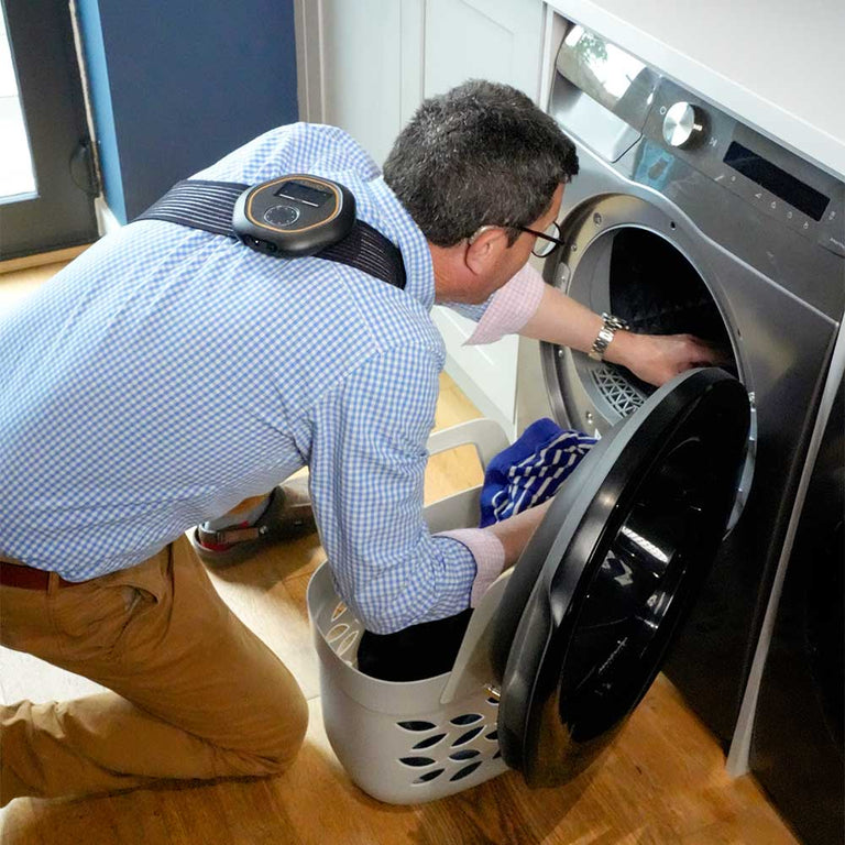 Man loading washing machine with CELLER8 on back
