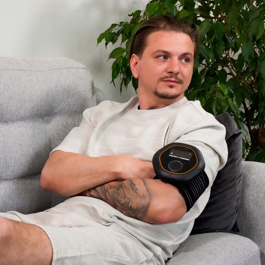 Man using CELLER8 on arm while on sofa