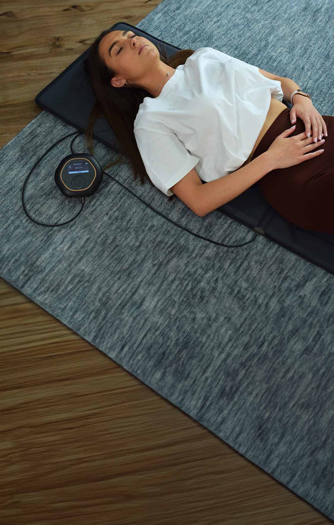 Laying on CELLER8 full body PEMF therapy mat