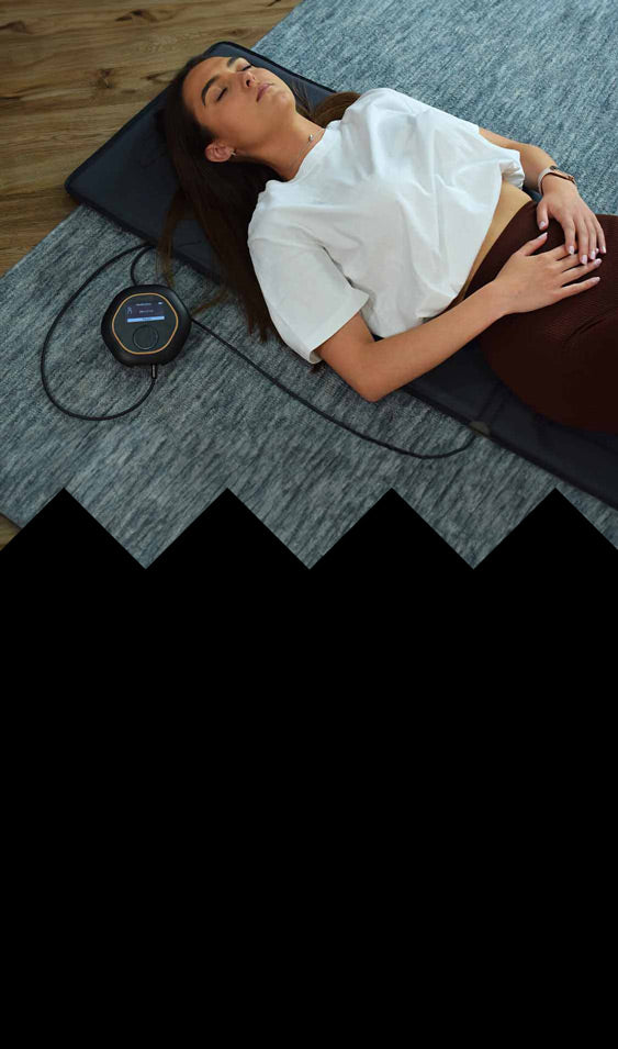 Laying on CELLER8 full body PEMF therapy mat