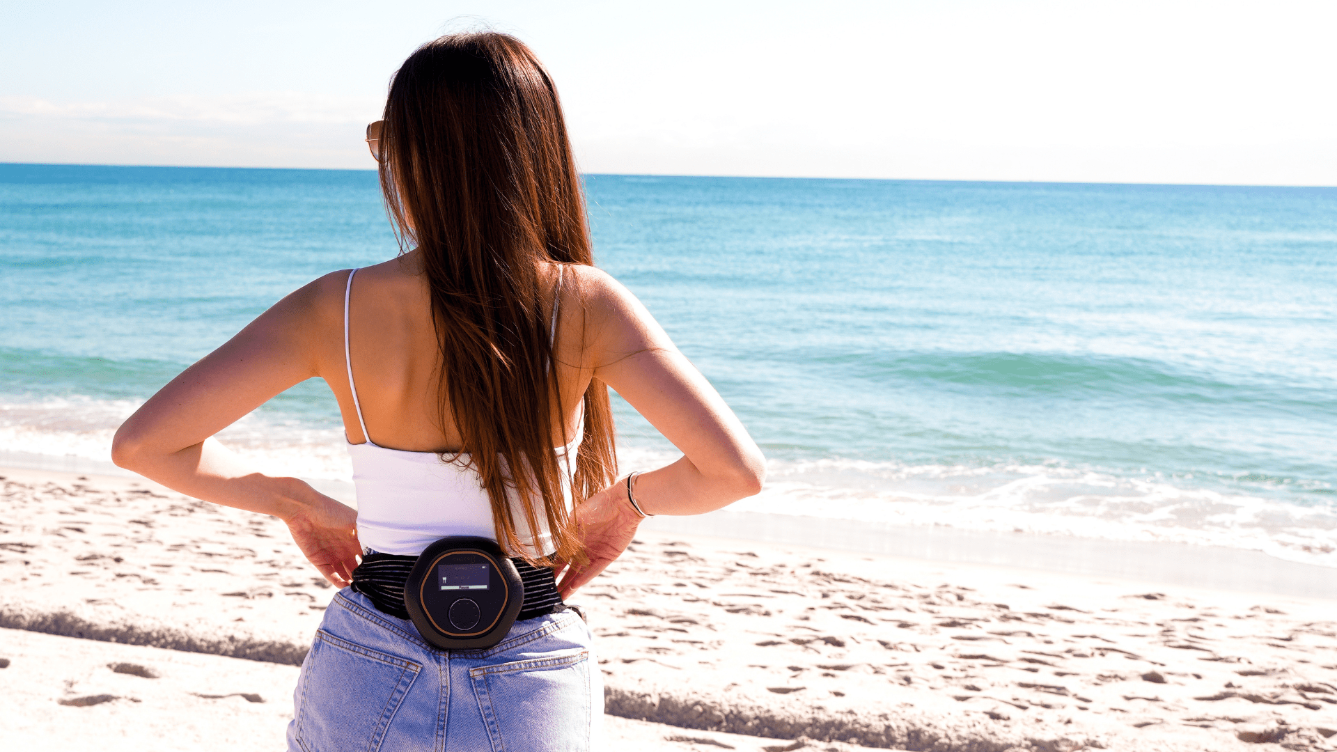 Woman wearing the CELLER8 PEMF device on her lower back.